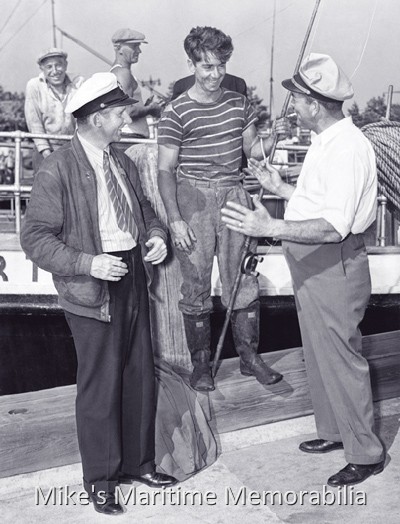 Captains Sid Wilsey and Fred Wrege, Brooklyn, NY – 1941 Standing alongside the 'EFFORT III" at Sheepshead Bay, Brooklyn, NY and conversing with an unknown deckhand are Captains Sid Wilsey and Fred Wrege. (We have to think that at least some of the dialog was about getting the deckhand's boot off Captain Wrege's suit jacket.) Captain Wilsey was the skipper of the "EFFORT II" at the time (Captain Fred's prior vessel). This 1941 photo is courtesy of the Captain Fred Wrege and Captain Charles VanDerVoort Families.