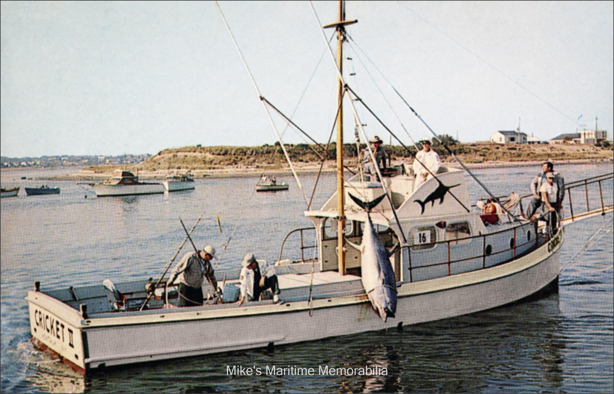 CRICKET II, Montauk, NY – 1966 Captain Frank Mundus' "CRICKET II" from Montauk, NY circa 1966. The "CRICKET II" was The boat was built in 1947 and launched in 1948 by Chesapeake bayman Tiffany Cockrell at the Glebe Point Motor Boat Co. in Burgess Store, VA. Captain Mundus originally sailed the "CRICKET II" from Brielle, NJ before relocating to Montauk, NY in July of 1951. Although this photo depicts a large tuna on the vessel's gin pole, Captain Mundus was one of the most famous shark fishermen of his time. The character 'Quint' in the 1975 Steven Spielberg movie 'Jaws' was based on the real life of Captain Mundus. He was indeed the godfather of 'Jaws'. The photo is courtesy of Captain John Bogan Jr.