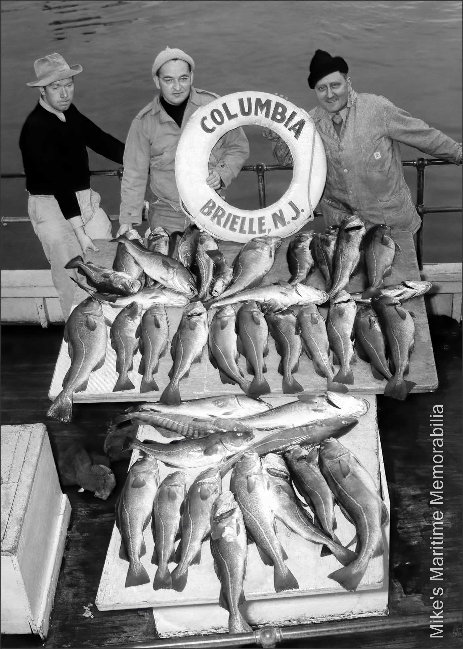 COLUMBIA, Brielle, NJ – 1946 "COLUMBIA" Cod catch circa 1946. Shown sporting a fine catch after a day of fishing are from left to right, Captain Jack Bogan and passengers Frank Strezeski from Clifton, NJ and Father Martin Piasecki pastor of Our Lady of Czestochowa church in Jersey City, NJ. An F.W. Tupper, Point Pleasant, NJ photograph.