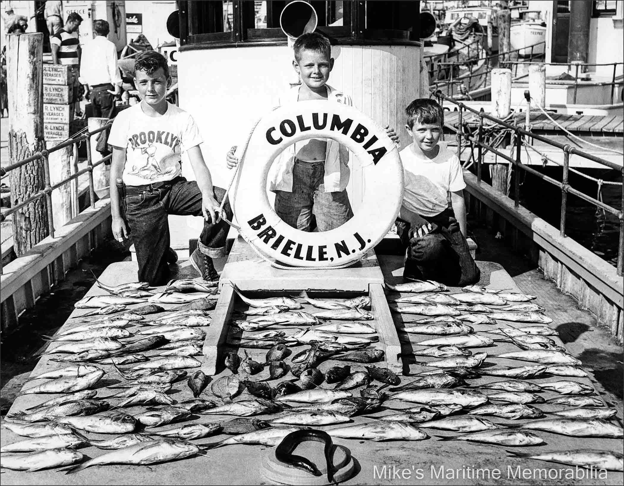 COLUMBIA fishing trip – 1950 The results of a fishing trip aboard Captain Jack Bogan's "COLUMBIA" in August 1950. Like any young lads, they were out fishing on a boat with their pals and happy as clams. Shown left to right are Jackie McGuire, a 10-year old Dave Bogan Sr. and Bob Bogan Sr.