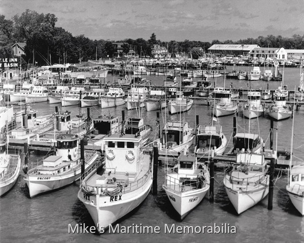 BRIELLE FLEET, Brielle, NJ – 1958 A vantage point on the Route 35 Memorial Bridge gives this view of the Brielle, NJ fishing fleet circa 1958. At the time, the Brielle party fishing boat fleet consisted of the "ESCORT", the "REX", the "FRISCO", the "COLUMBIA", the "PARAMOUNT II", the BAR-Q", the TAMBO V, the "TERESA", the "TAMBO III, the "CHAPPIE", the "CHAPPIE II" and the "CAPT. STAN".