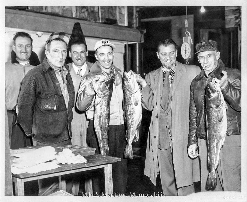 Captain Clair's Fish Market, Brooklyn, NY – 1953 Captain Clair's Fish Market, Sheepshead Bay, Brooklyn, NY circa 1953. In the foreground from left to right are Captain Eddie Clair, a young Michael Maffai Jr. of Mike's Tackle & Bait Shop, artist Jon Gnagy and Abe Seltzer. Photograph by Cecil Clovelly. Along with a big love for fishing, Jon Gnagy (1907-1981) was a self-taught artist most remembered for being America's original television art instructor, hosting "You Are an Artist", which began on the NBC network and his later syndicated "Learn to Draw" series. His shows aired from the early 1950s throughout the 1960s. Over fifteen million of Gnagy's drawing kits have been sold and the Philadelphia-based Martin F. Weber Company still manufactures Gnagy's drawing kits. Along with the fish market, Captain Eddie Clair operated the party boats "ROVER", "TAMBO" and "VICTORY" from Sheepshead Bay, and was the son of New York's Circle Line sightseeing cruises co-founder Frank Clair. Mike's Tackle & Bait shop was a familiar fixture on Emmons Ave in Sheepshead Bay, Brooklyn and run by the Maffai family for forty-five years before closing in 1997.