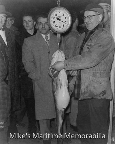 Weighing the pool winning codfish in Perth Amboy, NJ – 1960 Weighing the pool winning codfish on the dock by the "SEA PIGEON" at Perth Amboy, NJ in 1960. By the way people are dressed, the picture was probably taken on a Sunday evening.