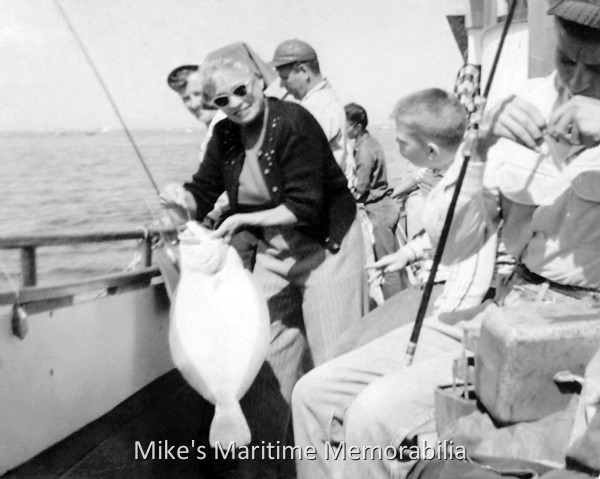 Family Fishing Fun – 1955 Fluke fishing aboard the "SEA PIGEON II" from Perth Amboy, NJ in July 1955. 'Mom' happily shows off her pool-winning Fluke (Summer Flounder) to her son.